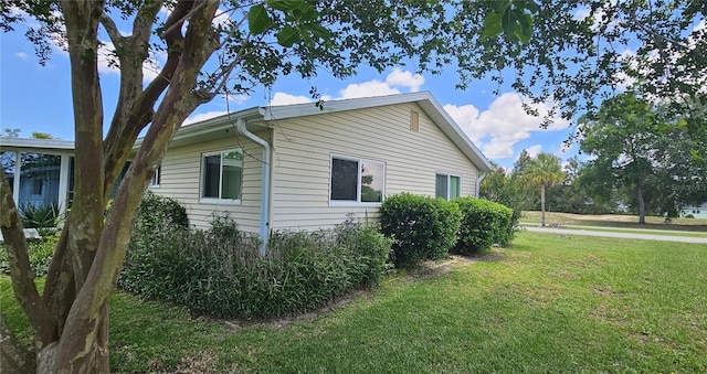 view of side of property with a lawn