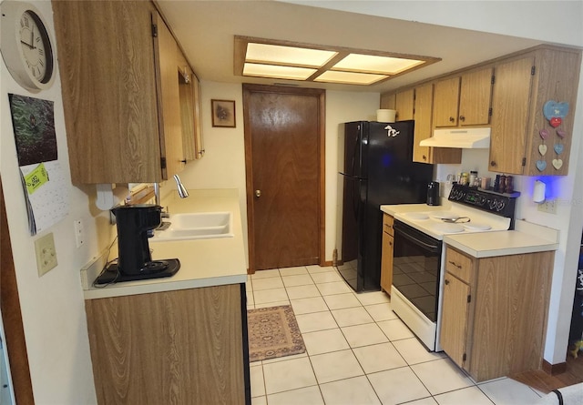 kitchen with electric range, under cabinet range hood, a sink, light countertops, and light tile patterned floors