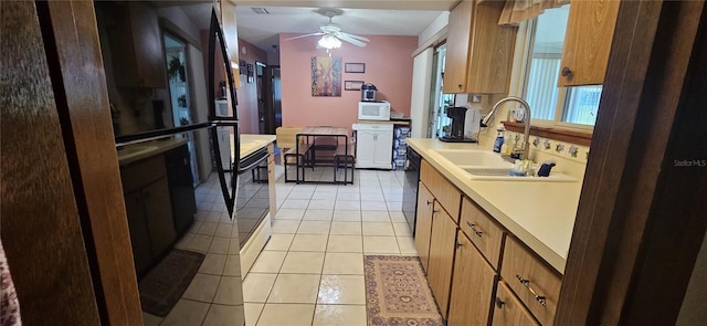 kitchen featuring a sink, light countertops, white microwave, dishwasher, and a ceiling fan