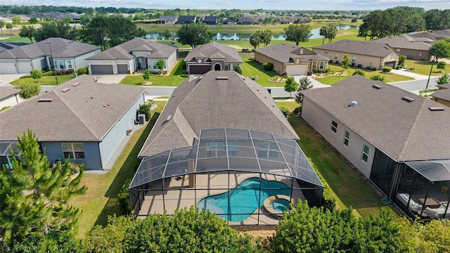 aerial view of residential area with a nearby body of water and a pool