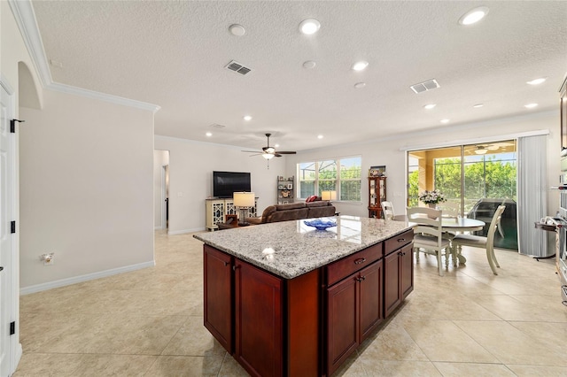 kitchen with ceiling fan, crown molding, reddish brown cabinets, a textured ceiling, and recessed lighting