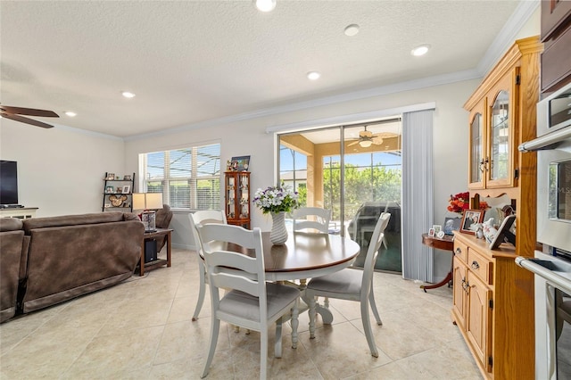 dining room featuring a ceiling fan, crown molding, a textured ceiling, light tile patterned flooring, and recessed lighting