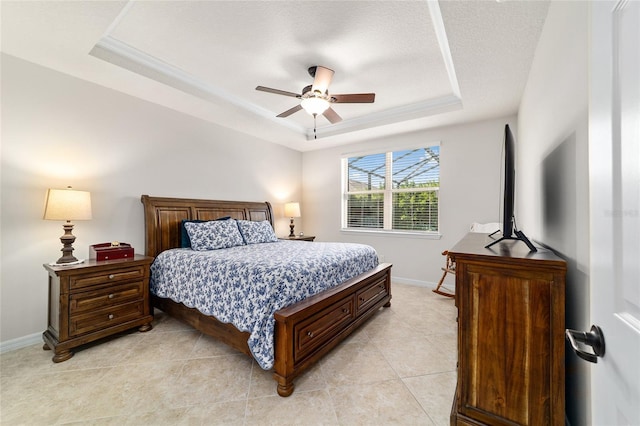bedroom featuring a raised ceiling, baseboards, light tile patterned floors, and a ceiling fan
