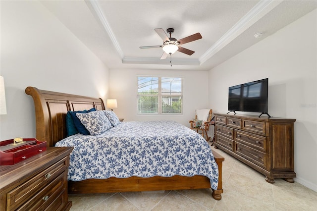 bedroom featuring a tray ceiling, ornamental molding, ceiling fan, light tile patterned floors, and baseboards