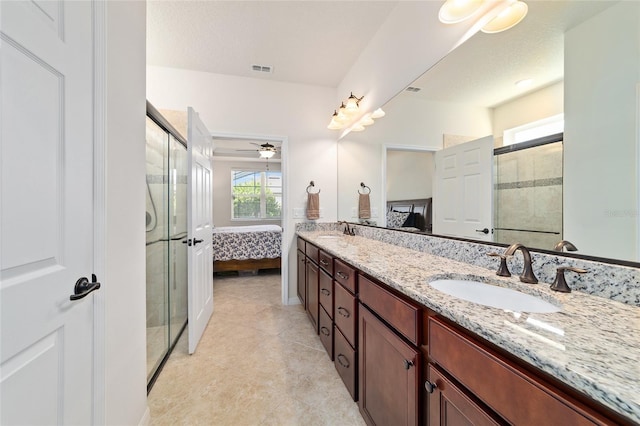 ensuite bathroom with a shower stall, healthy amount of natural light, and tile patterned flooring