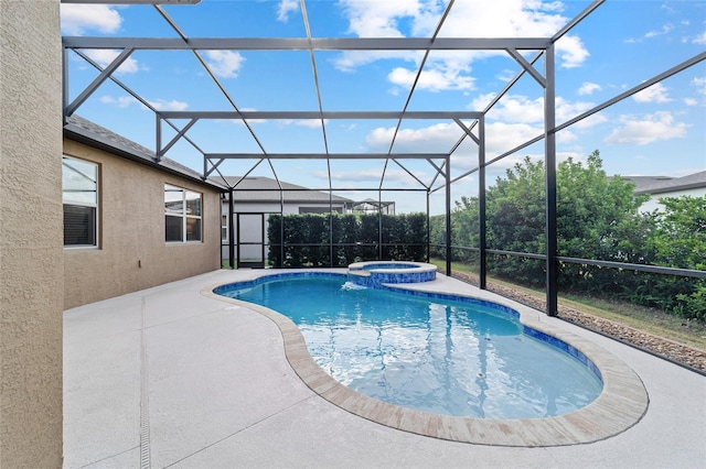 view of pool with a patio area, a pool with connected hot tub, and glass enclosure