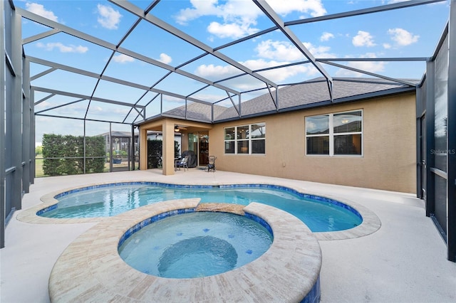 view of swimming pool with a patio, a pool with connected hot tub, a lanai, and a ceiling fan