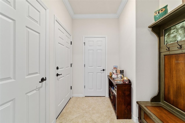 doorway to outside with ornamental molding, light tile patterned floors, and baseboards