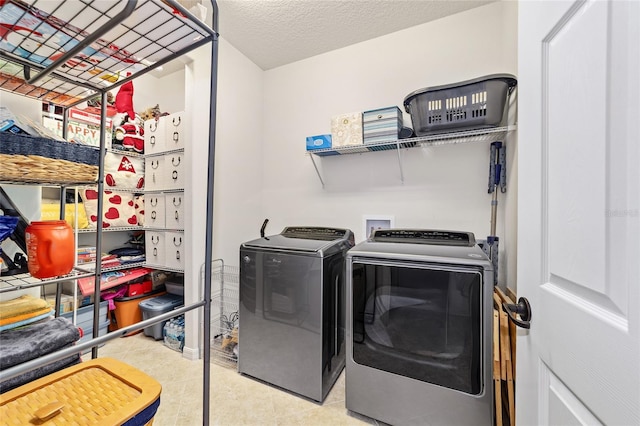 washroom featuring washer and clothes dryer and tile patterned flooring