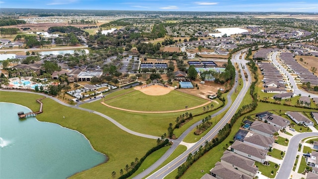 aerial view of property's location featuring a large body of water and nearby suburban area