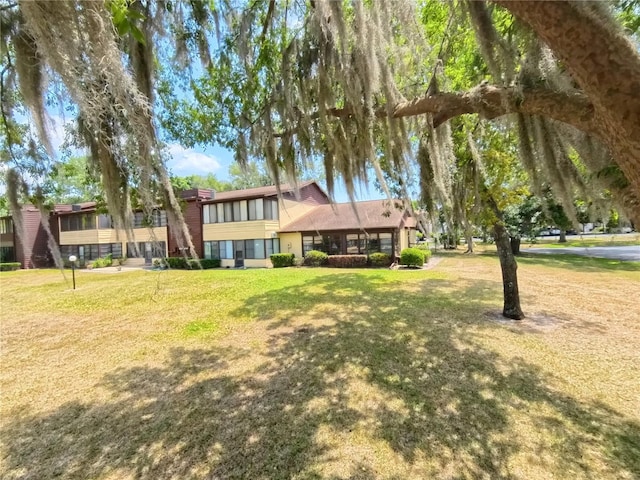 rear view of house featuring a lawn