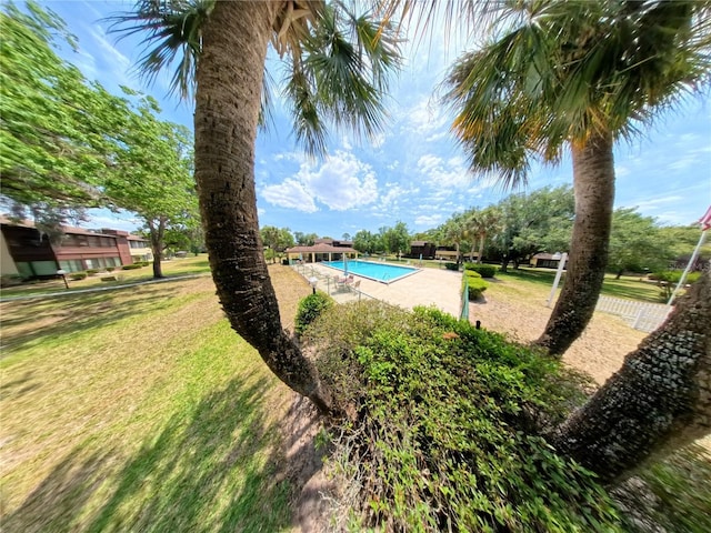 swimming pool featuring a lawn