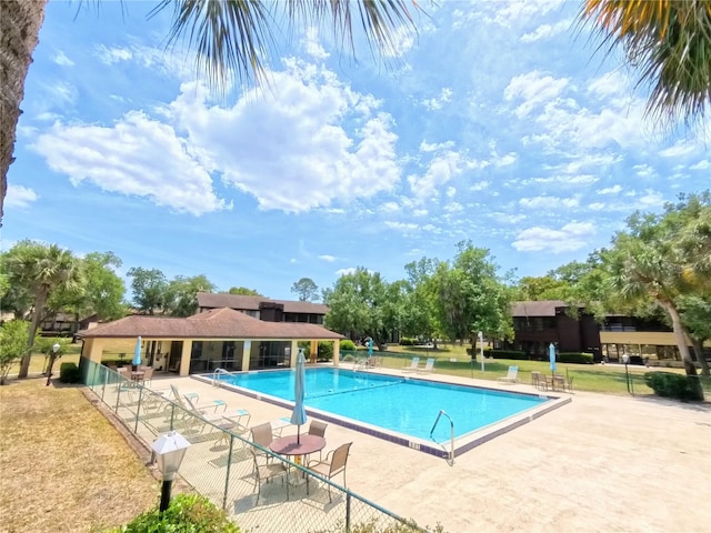 community pool featuring a patio and fence