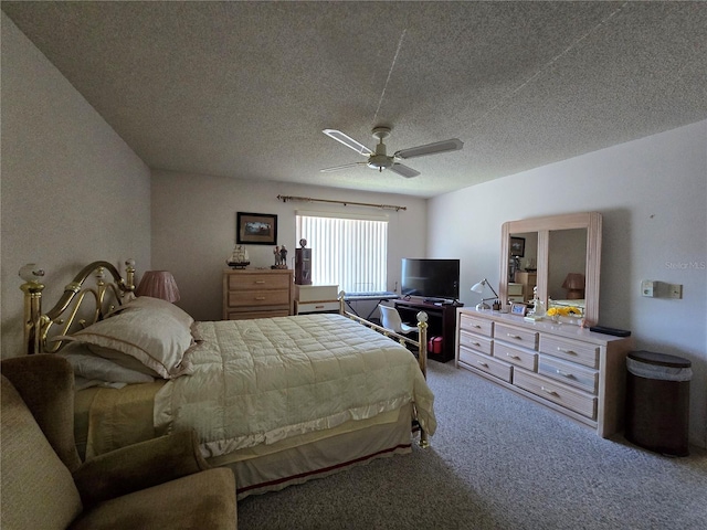 carpeted bedroom with a textured ceiling and a ceiling fan