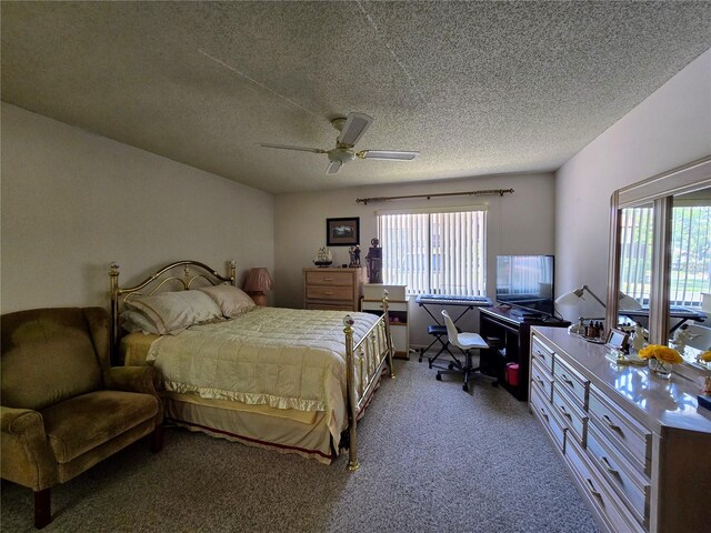 bedroom featuring a textured ceiling, carpet flooring, ceiling fan, and a desk