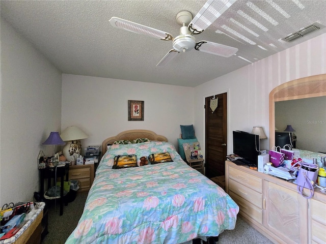 bedroom with carpet floors, a ceiling fan, and a textured ceiling