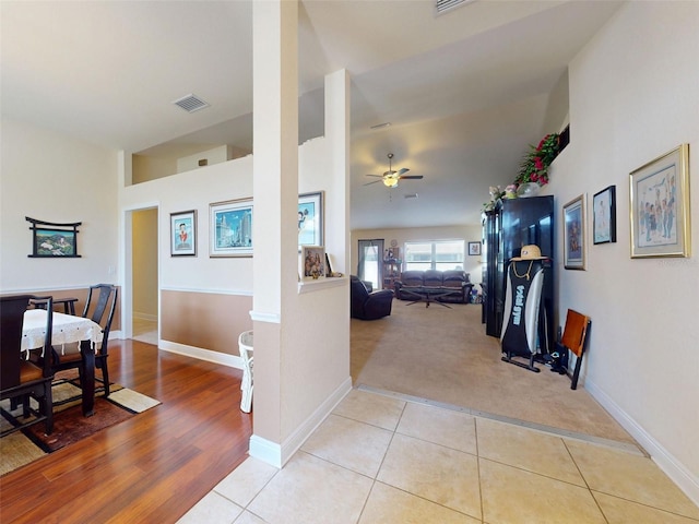 9677 SW 56th Cir, Ocala, FL 34476 - hallway with light tile patterned floors, light carpet, and baseboards