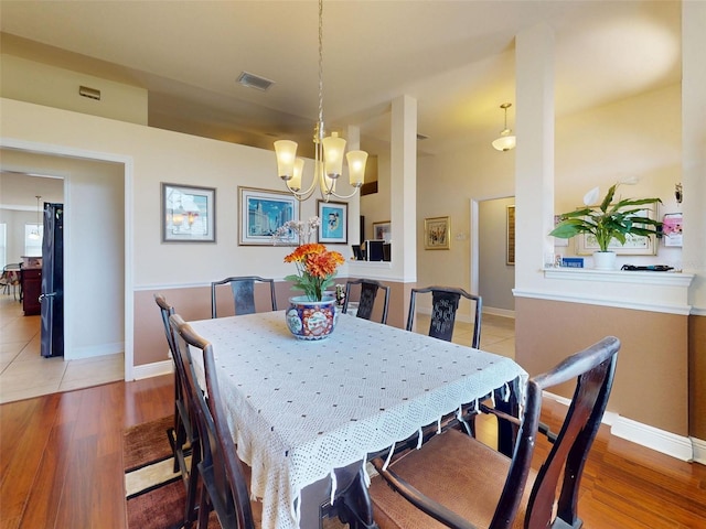 9677 SW 56th Cir, Ocala, FL 34476 - dining room featuring a chandelier, wood finished floors, and baseboards