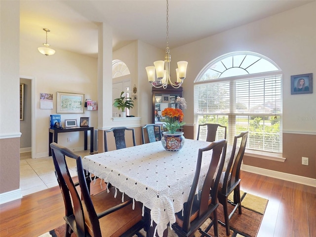9677 SW 56th Cir, Ocala, FL 34476 - dining space with healthy amount of natural light, a chandelier, baseboards, and light wood-style flooring