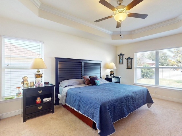 9677 SW 56th Cir, Ocala, FL 34476 - bedroom featuring a raised ceiling, ornamental molding, light carpet, baseboards, and a ceiling fan