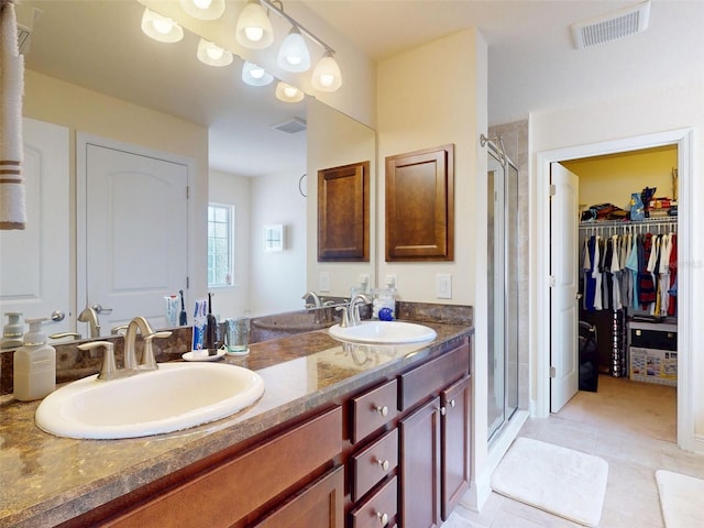 9677 SW 56th Cir, Ocala, FL 34476 - bathroom featuring a shower stall, double vanity, a spacious closet, and tile patterned floors