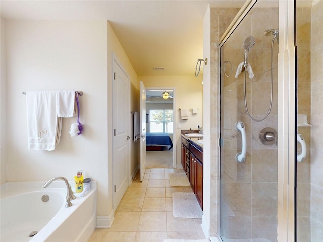 9677 SW 56th Cir, Ocala, FL 34476 - ensuite bathroom featuring vanity, a shower stall, tile patterned flooring, a garden tub, and baseboards