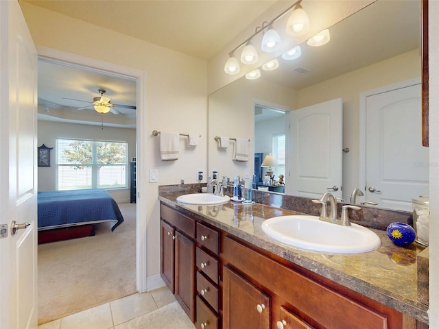 9677 SW 56th Cir, Ocala, FL 34476 - bathroom featuring connected bathroom, tile patterned floors, double vanity, ceiling fan, and baseboards