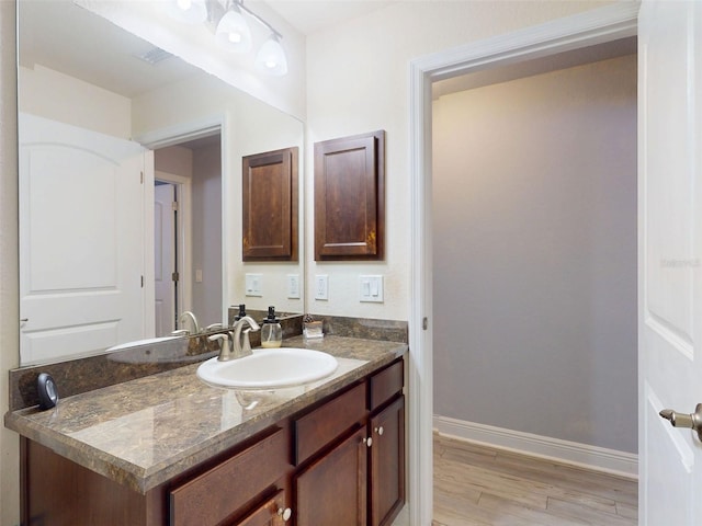 9677 SW 56th Cir, Ocala, FL 34476 - bathroom featuring wood finished floors, baseboards, and vanity