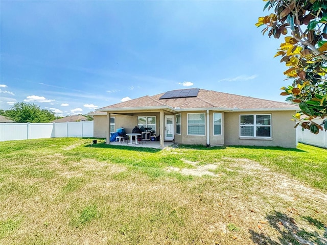 9677 SW 56th Cir, Ocala, FL 34476 - back of house with solar panels, stucco siding, and a patio area