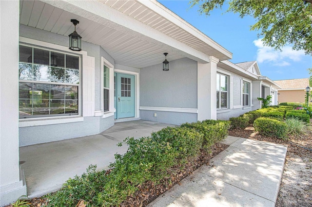 9287 SW 91st Court Rd, Ocala, FL 34481 - entrance to property featuring a porch and stucco siding