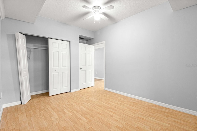 9287 SW 91st Court Rd, Ocala, FL 34481 - unfurnished bedroom with light wood-style flooring, baseboards, a closet, ceiling fan, and a textured ceiling