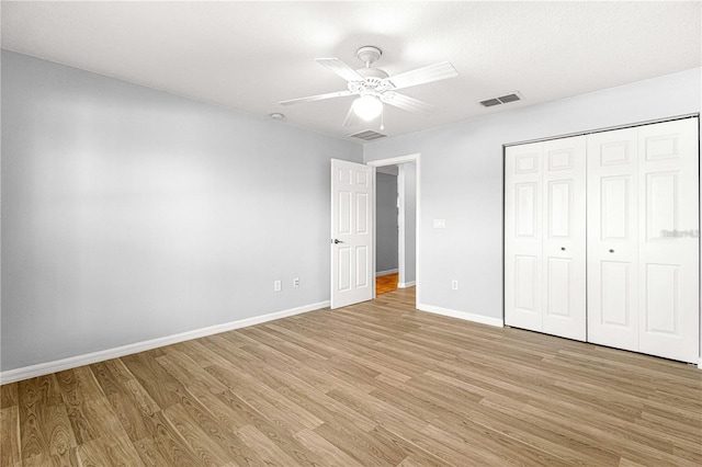 9287 SW 91st Court Rd, Ocala, FL 34481 - unfurnished bedroom with light wood-type flooring, baseboards, a closet, and a ceiling fan