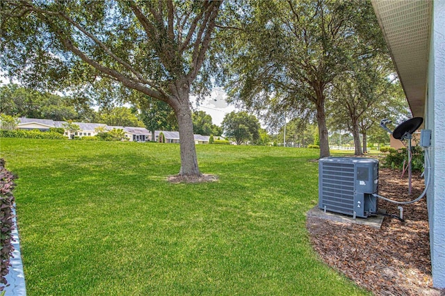 9287 SW 91st Court Rd, Ocala, FL 34481 - view of green lawn with central AC unit
