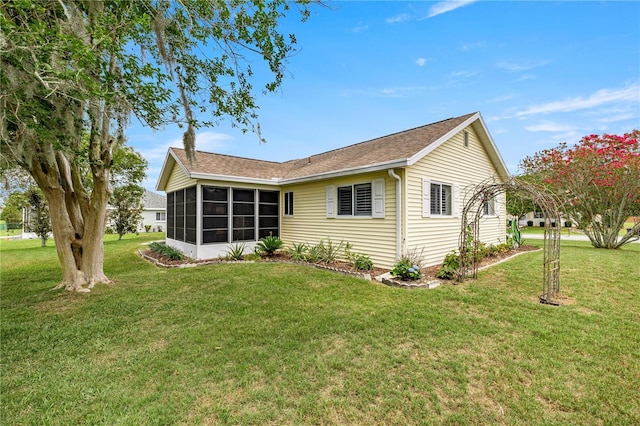 2158 NW 50th Ave, Ocala, FL 34482 - back of property featuring a sunroom, a yard, and roof with shingles