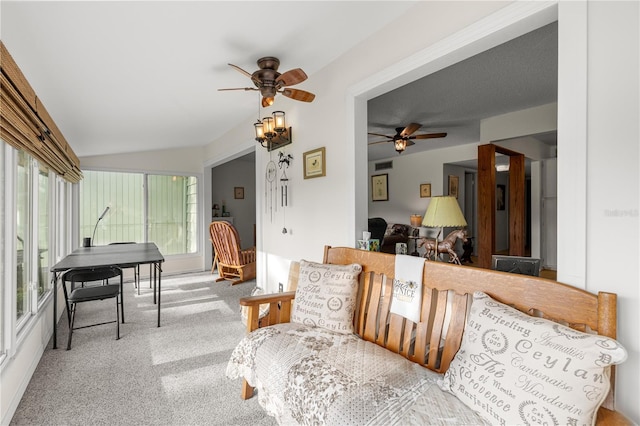 living area featuring a ceiling fan, vaulted ceiling, and carpet floors