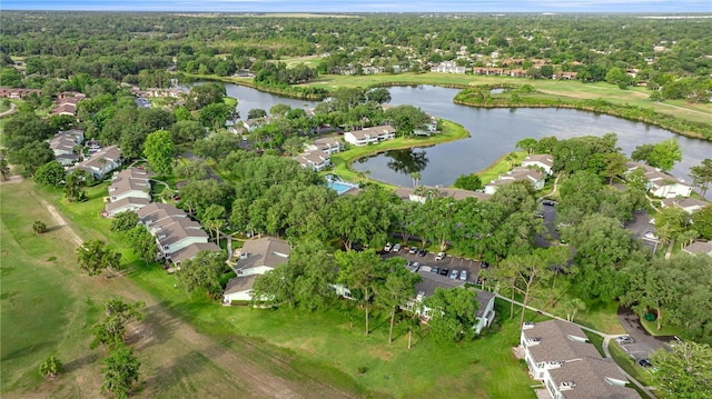 aerial view of property and surrounding area featuring nearby suburban area, a large body of water, and a local golf course
