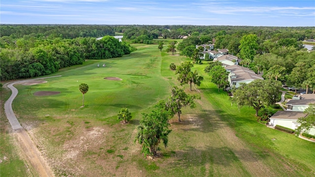 aerial view of property's location with a golf club and a forest