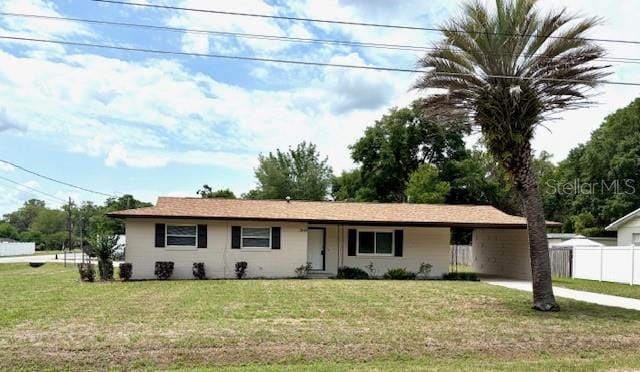 ranch-style house with an attached carport and concrete driveway