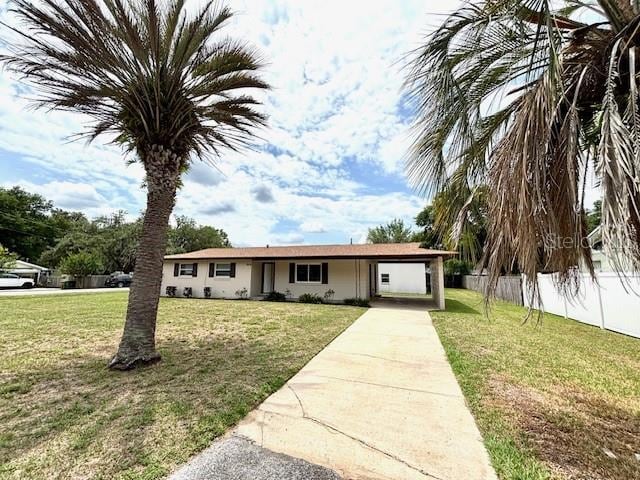 ranch-style home with driveway and a carport