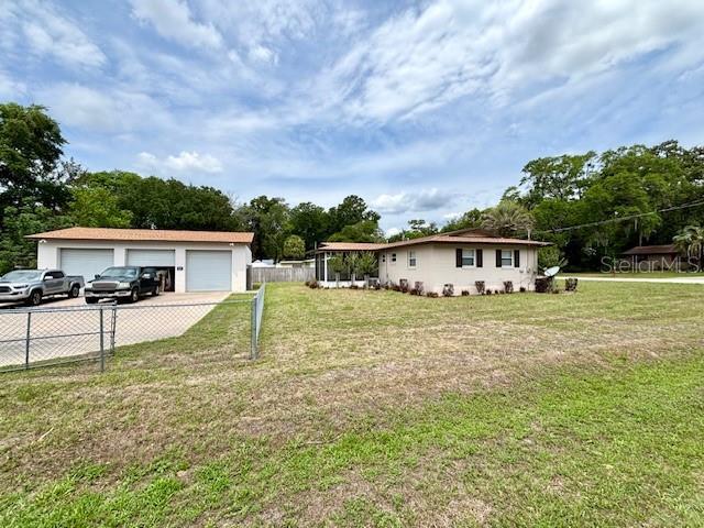 single story home featuring a detached garage