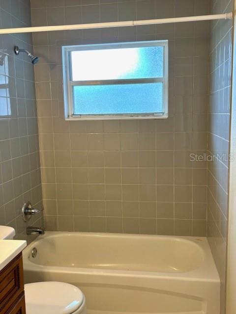 bathroom with vanity, shower / bathtub combination, and toilet