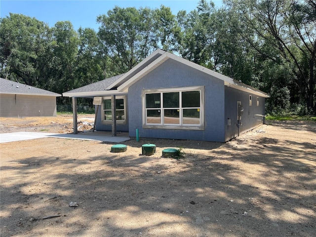 back of house with stucco siding