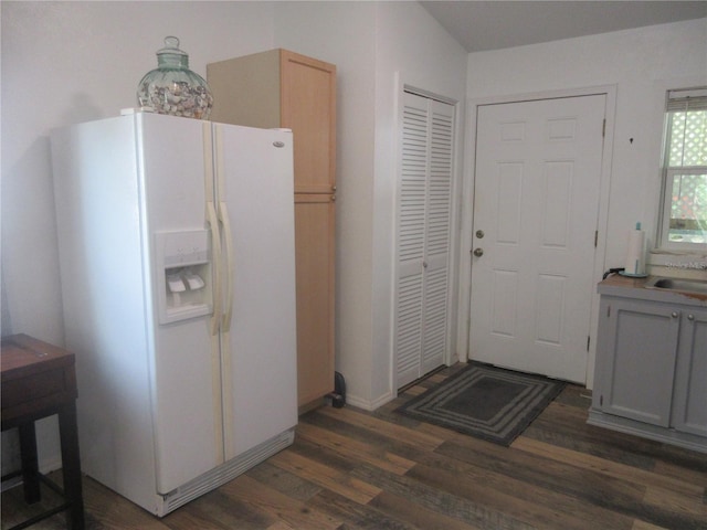 5949 SE 164th Ct, Ocklawaha, FL 32179 - kitchen featuring white fridge with ice dispenser, wood finished floors, and a sink