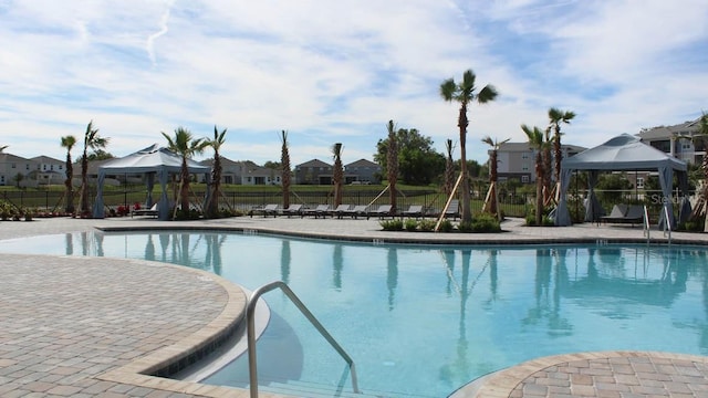 4235 SW 53rd Lane Rd, Ocala, FL 34474 - community pool featuring a gazebo, fence, a residential view, and a patio