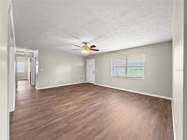10739 SE 44th Ter, Belleview, FL 34420 - unfurnished room featuring dark wood finished floors, baseboards, ceiling fan, and a textured ceiling