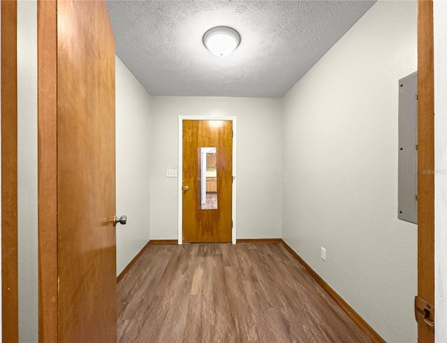 10739 SE 44th Ter, Belleview, FL 34420 - foyer with wood finished floors, a textured ceiling, baseboards, and electric panel