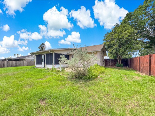 10739 SE 44th Ter, Belleview, FL 34420 - rear view of house featuring a sunroom and stucco siding