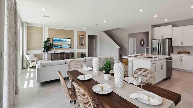 dining area featuring light tile patterned floors, stairway, and recessed lighting