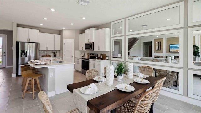 dining room with recessed lighting and light tile patterned floors
