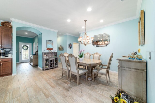 6868 SW 95th Cir, Ocala, FL 34481 - dining space featuring arched walkways, recessed lighting, light wood-style floors, a chandelier, and ornamental molding